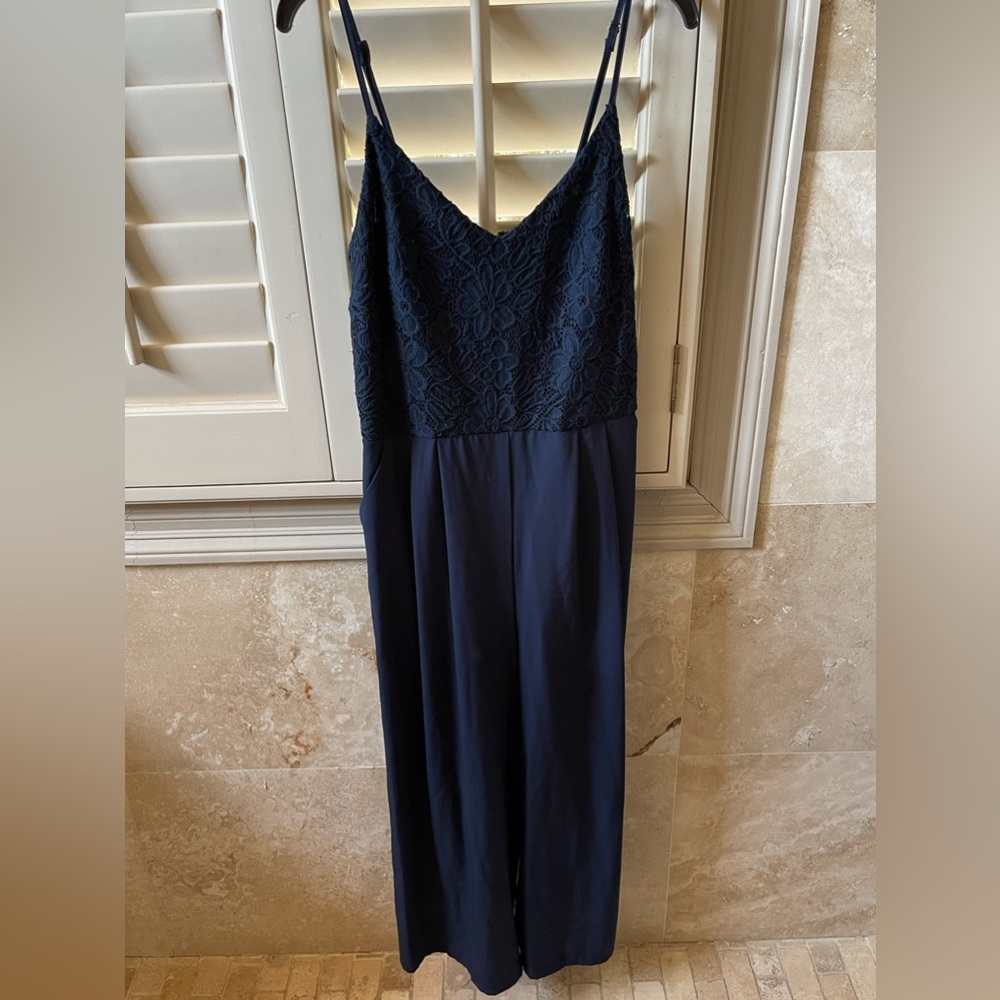 Gianni Bini navy blue jumpsuit with lacy top attached.